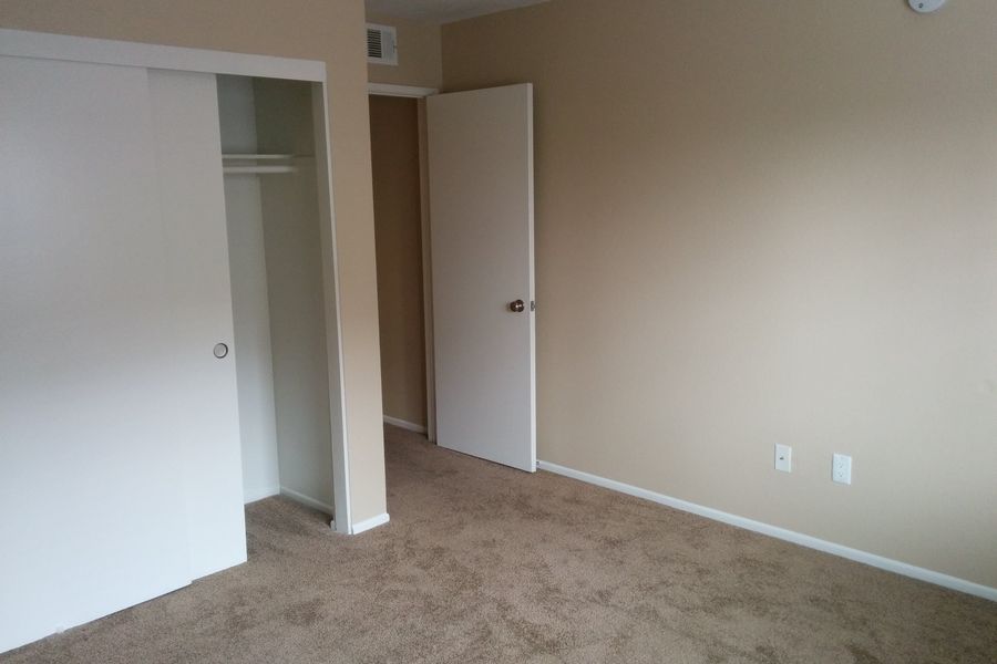 Bedroom cleared out and empty after a room cleanout, with an open empty closet